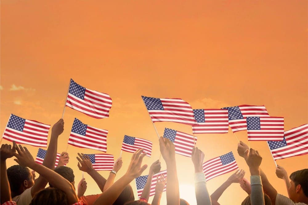 Crowd waiving American flags. Flag of USA.